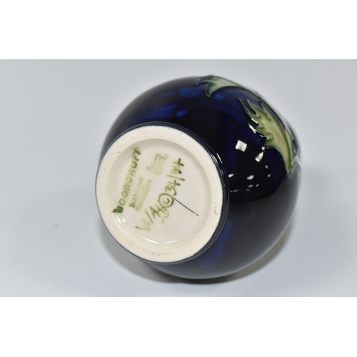 1013 - A MOORCROFT POTTERY 'ANEMONE' VASE, the small baluster vase tube lined with purple anemone flowers o... 