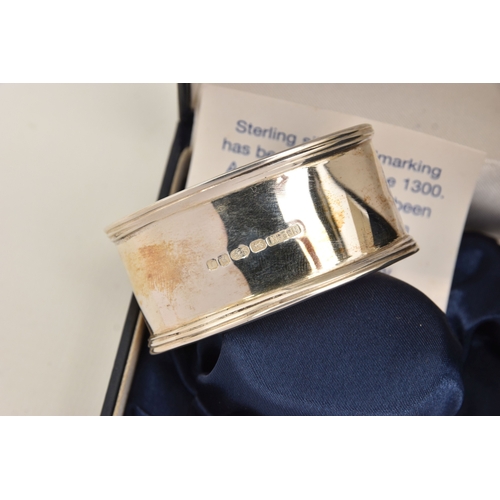 592 - THREE BOXED SILVER NAPKIN RINGS, two oval form and a small circular napkin rings, each with a full s... 