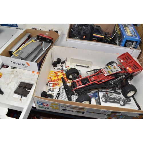 947 - THREE BOXES AND LOOSE REMOTE CONTROL CARS AND TRAINS to include a Kyosho 1:10 scale off road racing ... 
