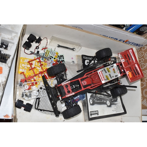 947 - THREE BOXES AND LOOSE REMOTE CONTROL CARS AND TRAINS to include a Kyosho 1:10 scale off road racing ... 