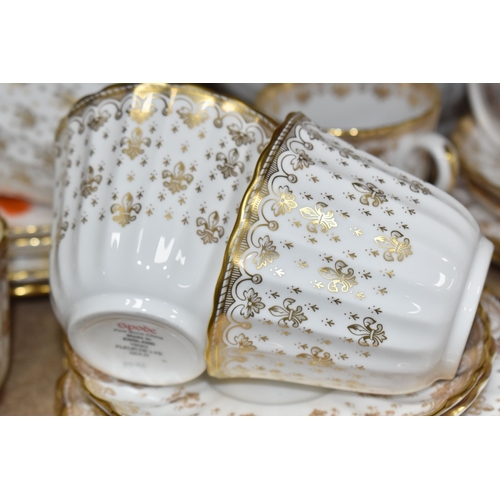 974 - A SPODE 'FLEUR DE LYS GOLD' DINNER AND TEA SERVICE comprising a tureen, a sauce boat and stand, a me... 