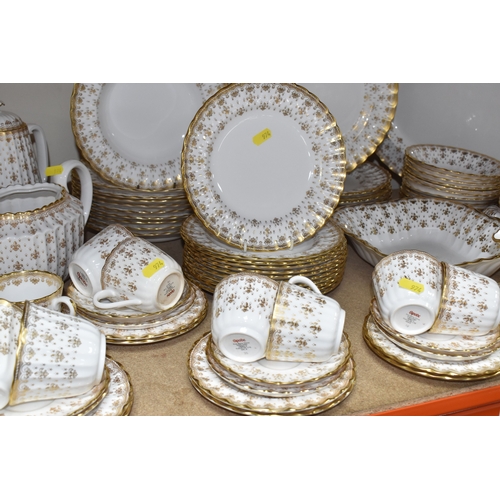 974 - A SPODE 'FLEUR DE LYS GOLD' DINNER AND TEA SERVICE comprising a tureen, a sauce boat and stand, a me... 