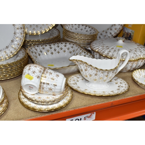 974 - A SPODE 'FLEUR DE LYS GOLD' DINNER AND TEA SERVICE comprising a tureen, a sauce boat and stand, a me... 