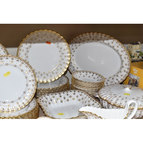 974 - A SPODE 'FLEUR DE LYS GOLD' DINNER AND TEA SERVICE comprising a tureen, a sauce boat and stand, a me... 