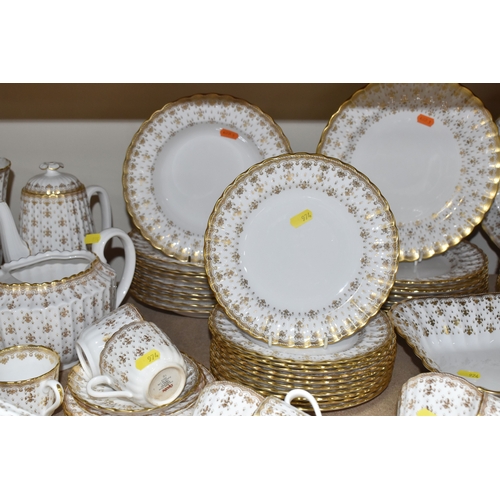 974 - A SPODE 'FLEUR DE LYS GOLD' DINNER AND TEA SERVICE comprising a tureen, a sauce boat and stand, a me... 