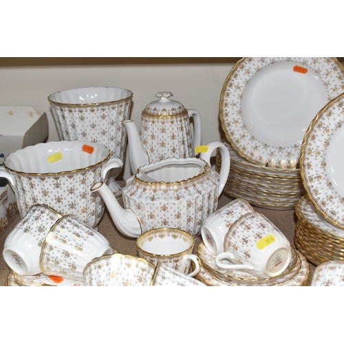 974 - A SPODE 'FLEUR DE LYS GOLD' DINNER AND TEA SERVICE comprising a tureen, a sauce boat and stand, a me... 
