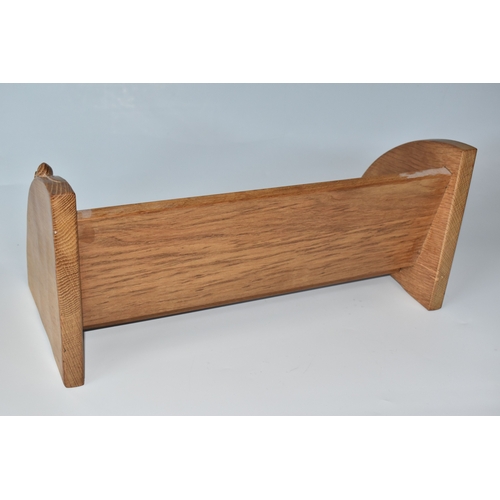 801 - A ROBERT MOUSEMAN THOMPSON OAK BOOK SHELF, single shelf with shaped adzed ends, carved with signatur... 