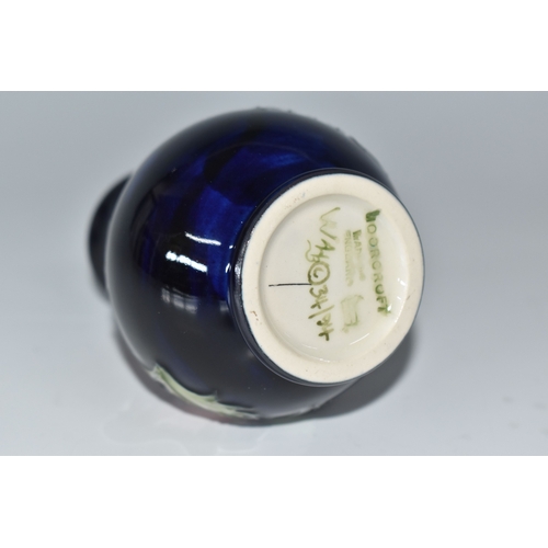 815 - A MOORCROFT POTTERY 'ANEMONE' VASE, the small baluster vase tube lined with purple anemone flowers o... 