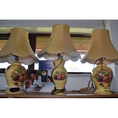 800 - A GROUP OF THREE AYNSLEY 'ORCHARD GOLD' TABLE LAMPS, comprising two matching transfer print lamps, i... 