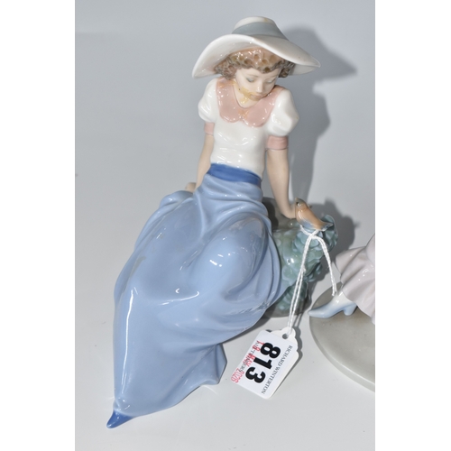 813 - THREE NAO FIGURINES, comprising 'Girl sitting with a bird', (has had noticeable restoration to the n... 