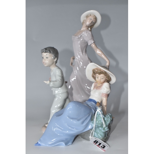 813 - THREE NAO FIGURINES, comprising 'Girl sitting with a bird', (has had noticeable restoration to the n... 