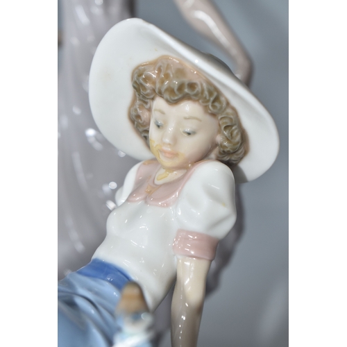 813 - THREE NAO FIGURINES, comprising 'Girl sitting with a bird', (has had noticeable restoration to the n... 