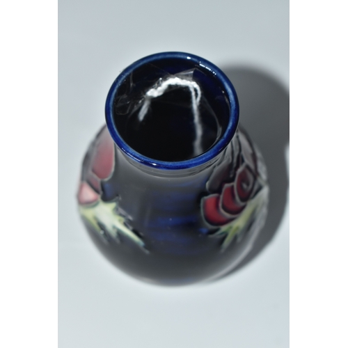 815 - A MOORCROFT POTTERY 'ANEMONE' VASE, the small baluster vase tube lined with purple anemone flowers o... 