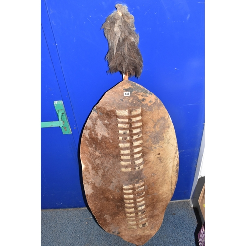843 - AN AFRICAN ZULU STYLE SHIELD of traditional elongated oval form, constructed from animal hide with r... 