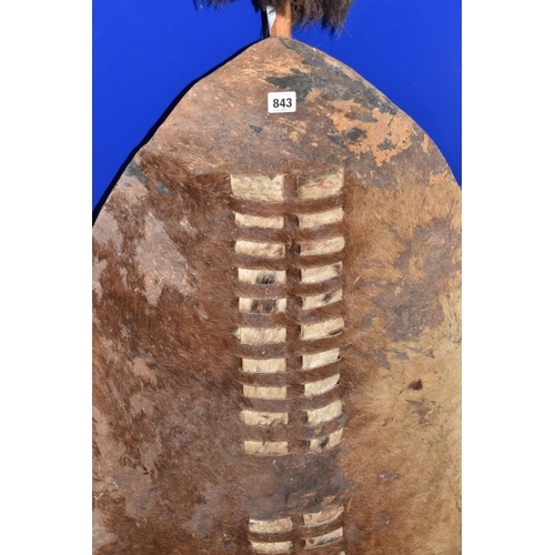 843 - AN AFRICAN ZULU STYLE SHIELD of traditional elongated oval form, constructed from animal hide with r... 
