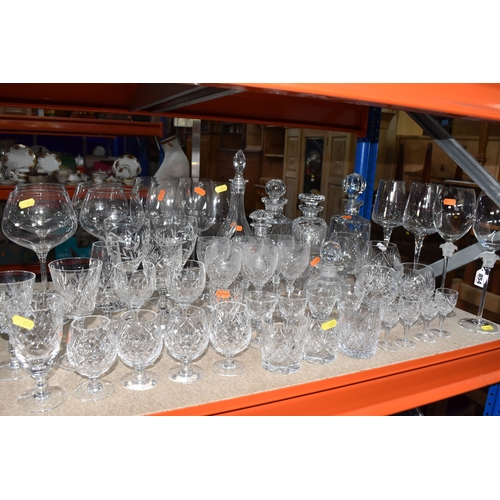 854 - A LARGE GROUP OF CRYSTAL AND GLASS DRINKING VESSELS to include two long stemmed Versace wine glasses... 