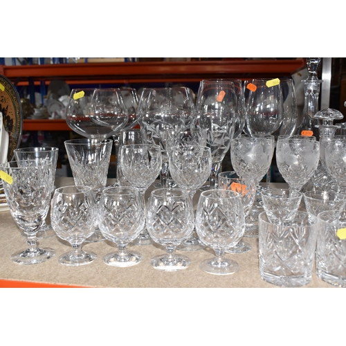 854 - A LARGE GROUP OF CRYSTAL AND GLASS DRINKING VESSELS to include two long stemmed Versace wine glasses... 