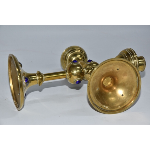 824 - A PAIR OF GEORGE BETJEMANN & SONS CANDLESTICKS, the brass arts and crafts style candlesticks with bl... 