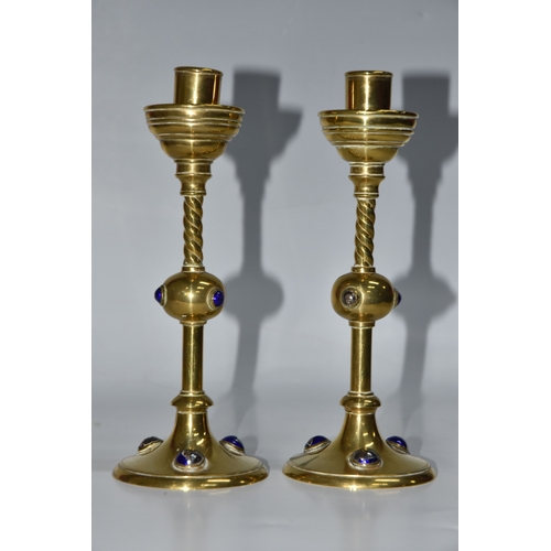 824 - A PAIR OF GEORGE BETJEMANN & SONS CANDLESTICKS, the brass arts and crafts style candlesticks with bl... 