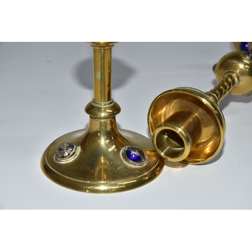 824 - A PAIR OF GEORGE BETJEMANN & SONS CANDLESTICKS, the brass arts and crafts style candlesticks with bl... 