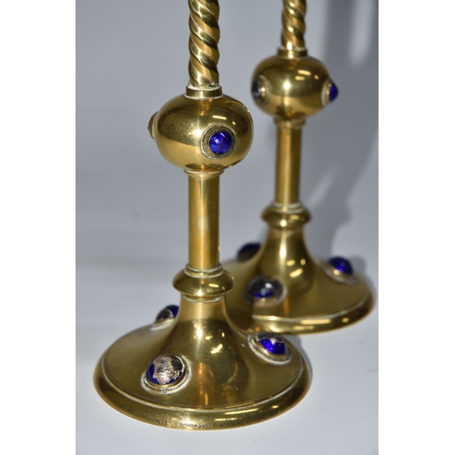 824 - A PAIR OF GEORGE BETJEMANN & SONS CANDLESTICKS, the brass arts and crafts style candlesticks with bl... 