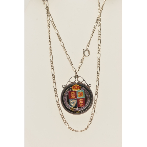 466 - AN 1887 SHILLING PENDANT, enamelled pendant in a white metal mount, suspended from a white metal fig... 