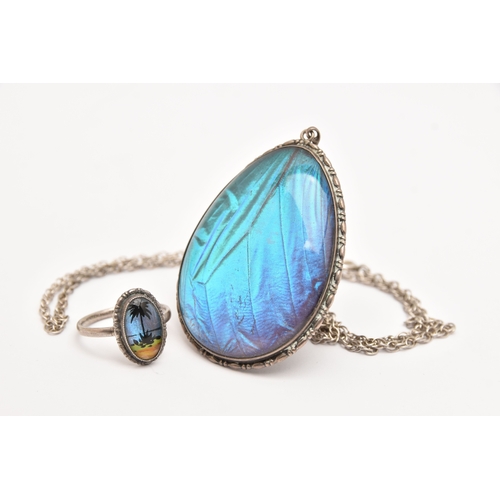 472 - A LARGE WHITE METAL BUTTERFLY WING PENDANT WITH RING, a large tear drop form pendant, fitted with a ... 