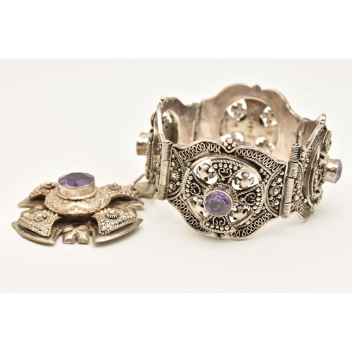 473 - A WHITE METAL BRACELET AND PENDANT, a large white metal bracelet designed and four panels with malta... 
