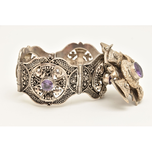 473 - A WHITE METAL BRACELET AND PENDANT, a large white metal bracelet designed and four panels with malta... 