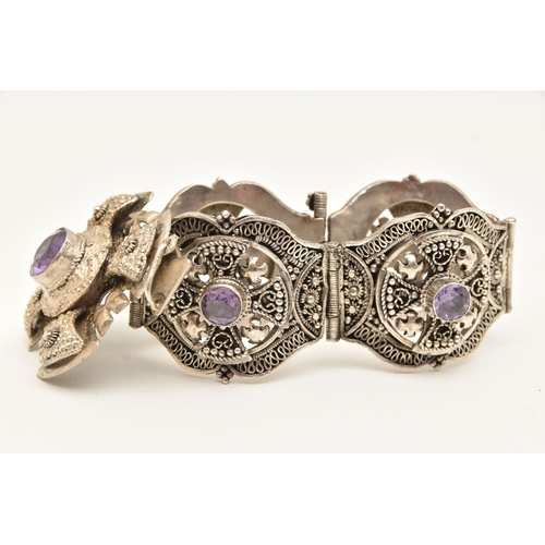 473 - A WHITE METAL BRACELET AND PENDANT, a large white metal bracelet designed and four panels with malta... 