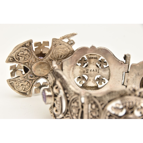 473 - A WHITE METAL BRACELET AND PENDANT, a large white metal bracelet designed and four panels with malta... 