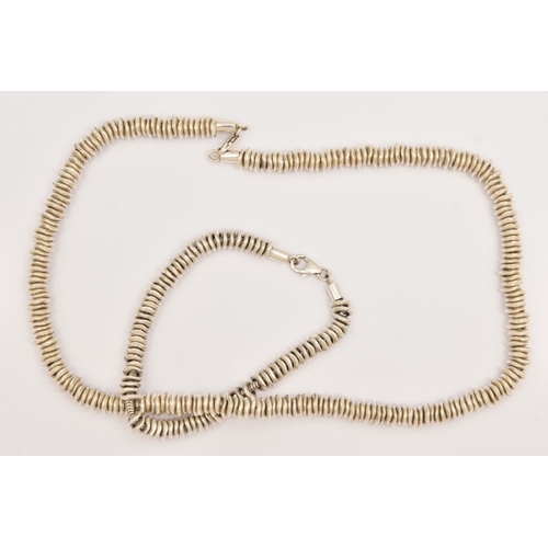 474 - A WHITE METAL NECKLACE AND BRACELET SET, a sweetie style necklace and bracelet fitted with a lobster... 