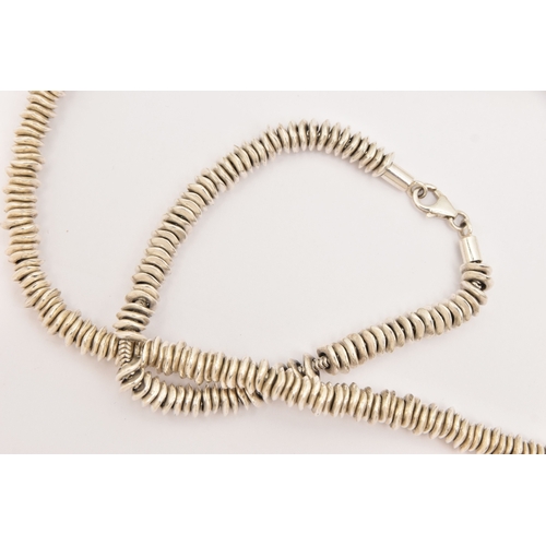 474 - A WHITE METAL NECKLACE AND BRACELET SET, a sweetie style necklace and bracelet fitted with a lobster... 