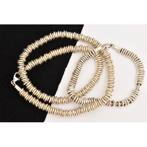 474 - A WHITE METAL NECKLACE AND BRACELET SET, a sweetie style necklace and bracelet fitted with a lobster... 