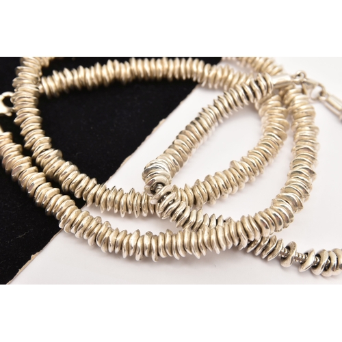 474 - A WHITE METAL NECKLACE AND BRACELET SET, a sweetie style necklace and bracelet fitted with a lobster... 