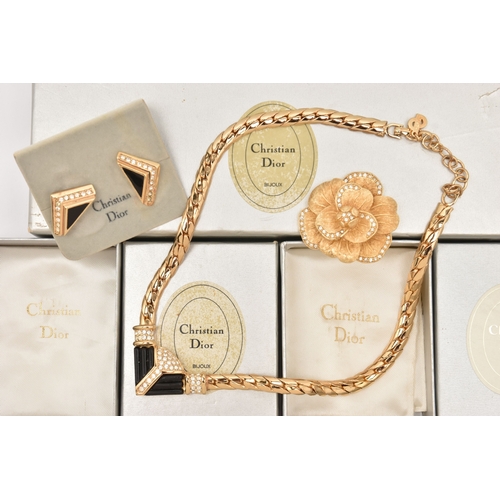 483 - THREE BOXED ITEMS OF COSTUME JEWELLERY ITEMS, to include a rose brooch signed 'Chr.Dior', a pendant ... 