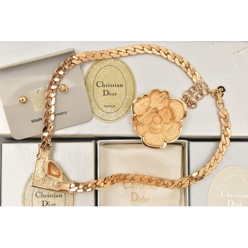 483 - THREE BOXED ITEMS OF COSTUME JEWELLERY ITEMS, to include a rose brooch signed 'Chr.Dior', a pendant ... 