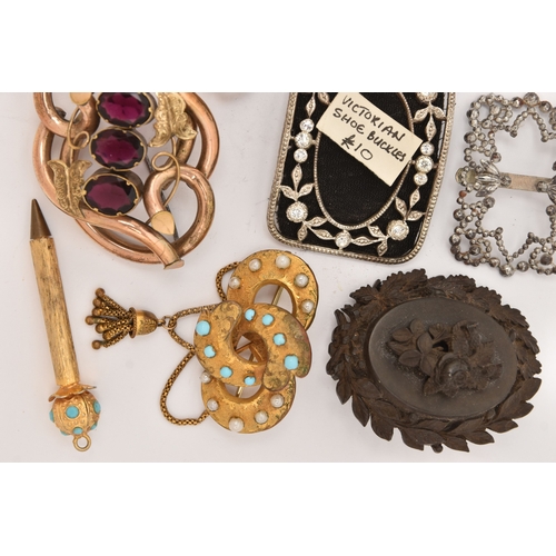 510 - AN ASSORTMENT OF ITEMS, to include a gold plated red paste set brooch, two carved vulcanite high rel... 