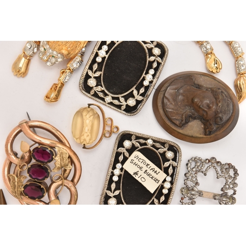 510 - AN ASSORTMENT OF ITEMS, to include a gold plated red paste set brooch, two carved vulcanite high rel... 