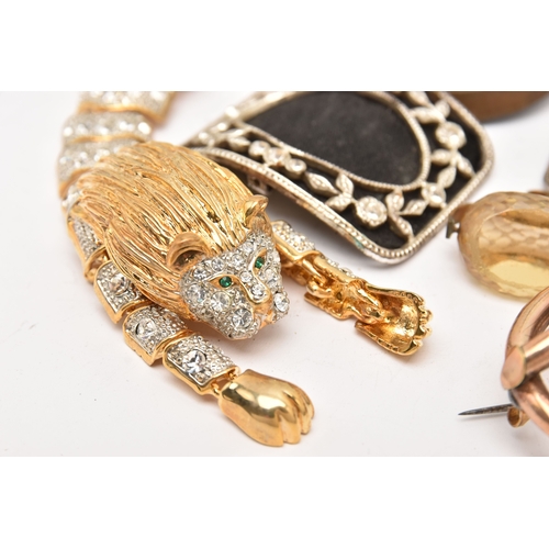 510 - AN ASSORTMENT OF ITEMS, to include a gold plated red paste set brooch, two carved vulcanite high rel... 