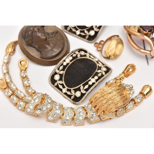 510 - AN ASSORTMENT OF ITEMS, to include a gold plated red paste set brooch, two carved vulcanite high rel... 