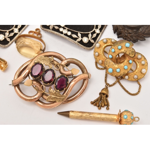 510 - AN ASSORTMENT OF ITEMS, to include a gold plated red paste set brooch, two carved vulcanite high rel... 