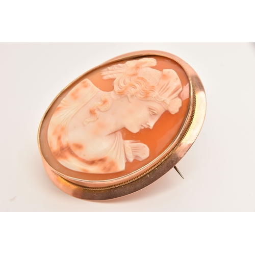 511 - A ROSE METAL CAMEO BROOCH, of an oval form, carved shell cameo depicting a lady in profile, collet s... 