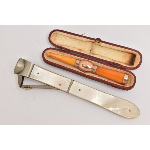 514 - A CASED AMBER AND GOLD CHEROOT AND A CIGAR CUTTER, the polished amber cheroot with rose gold mounts,... 