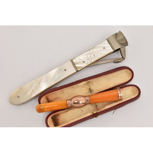 514 - A CASED AMBER AND GOLD CHEROOT AND A CIGAR CUTTER, the polished amber cheroot with rose gold mounts,... 