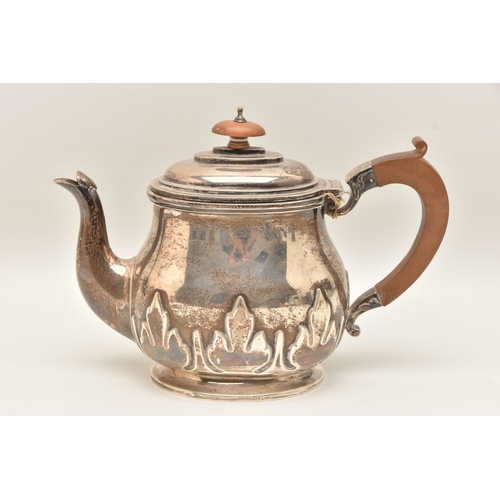 524 - AN EARLY 20TH CENTURY SILVER TEAPOT, foliate pattern, fitted with a light wooden handle and finial, ... 