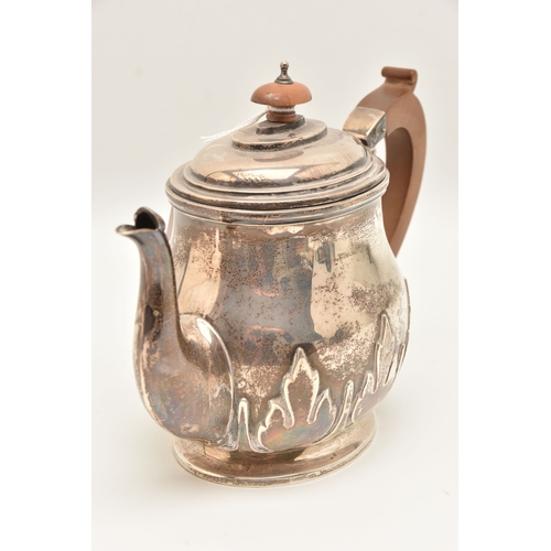 524 - AN EARLY 20TH CENTURY SILVER TEAPOT, foliate pattern, fitted with a light wooden handle and finial, ... 