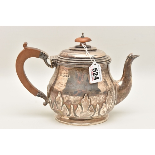 524 - AN EARLY 20TH CENTURY SILVER TEAPOT, foliate pattern, fitted with a light wooden handle and finial, ... 