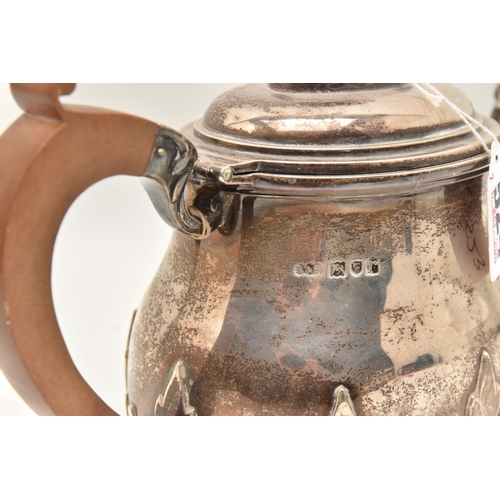524 - AN EARLY 20TH CENTURY SILVER TEAPOT, foliate pattern, fitted with a light wooden handle and finial, ... 