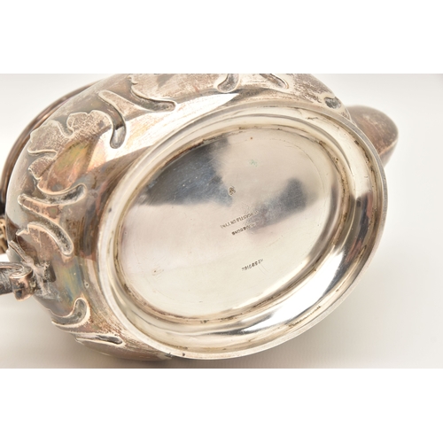 524 - AN EARLY 20TH CENTURY SILVER TEAPOT, foliate pattern, fitted with a light wooden handle and finial, ... 